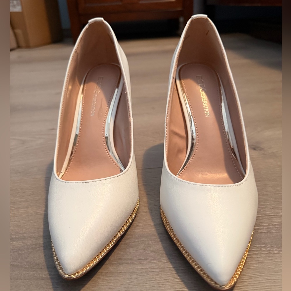BCBG pumps. White with gold grommet accent detail. Size 8.
